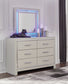 Zyniden King Upholstered Panel Bed with Mirrored Dresser and Chest