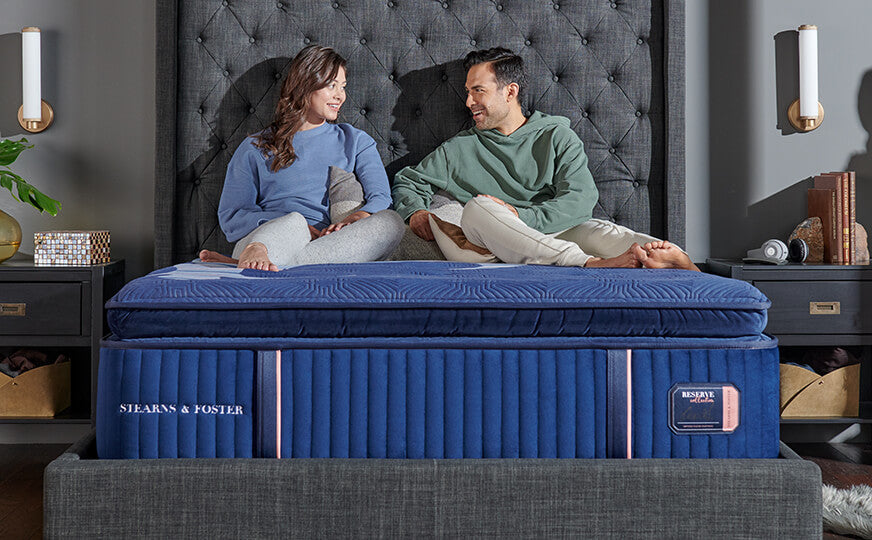 Couple sitting on pillowtop Stearns & Foster Reserve mattress